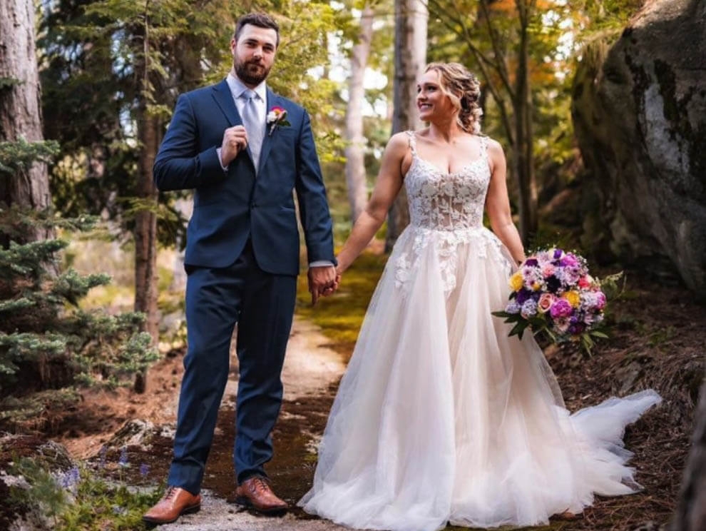 Сouple wearing a white gown and a blue suit