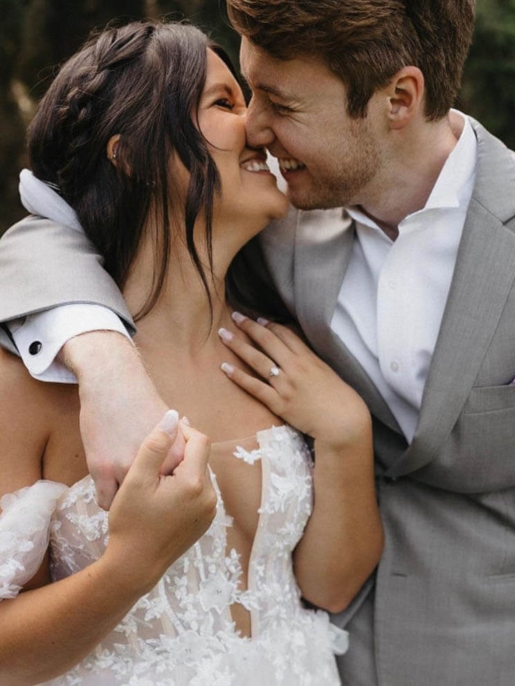 Сouple wearing a white gown and a gray suit